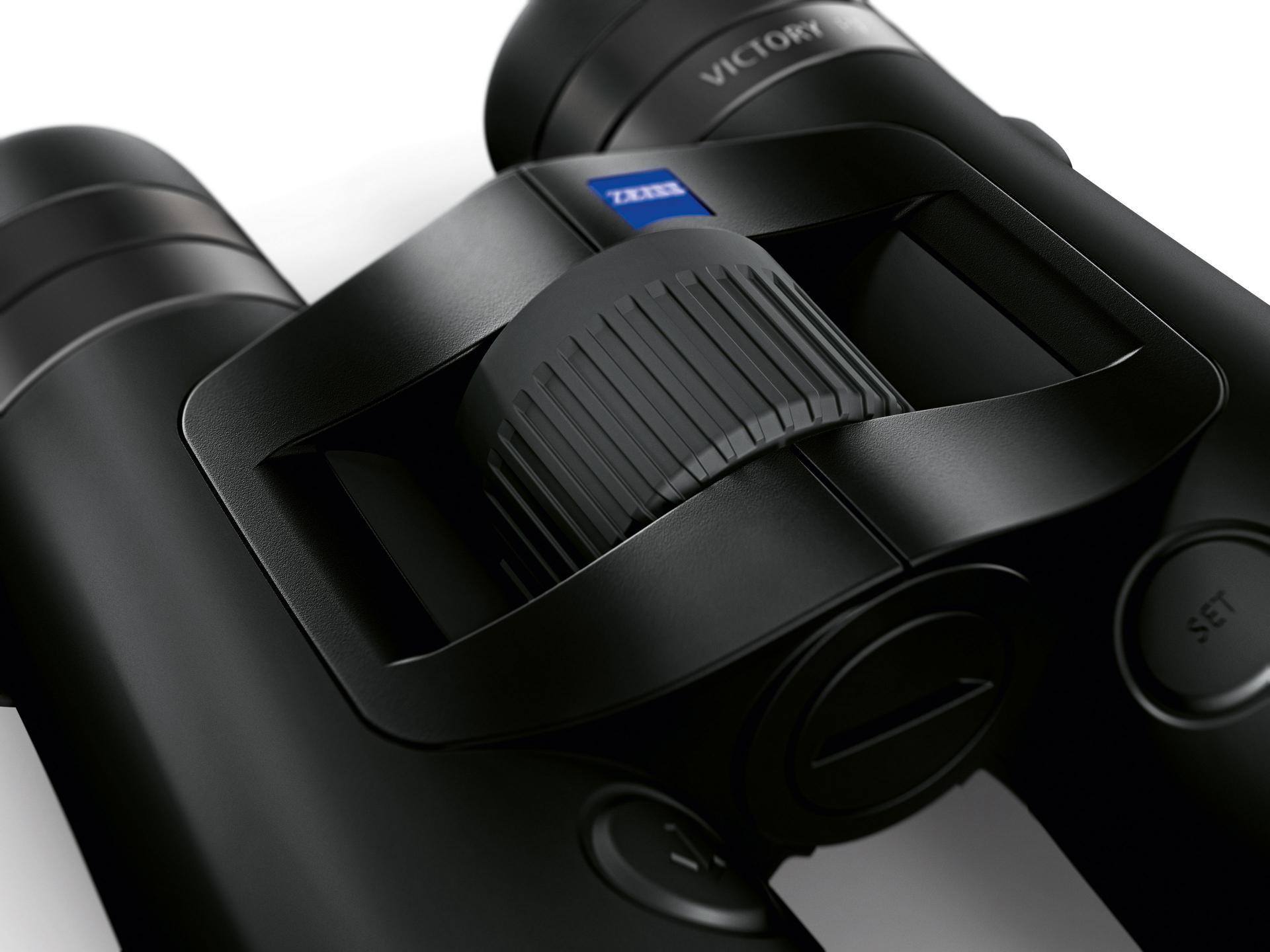 Close-up view of a black ZEISS binocular focusing wheel with the ZEISS logo clearly visible.